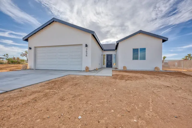 a view of garage yard and front view of house