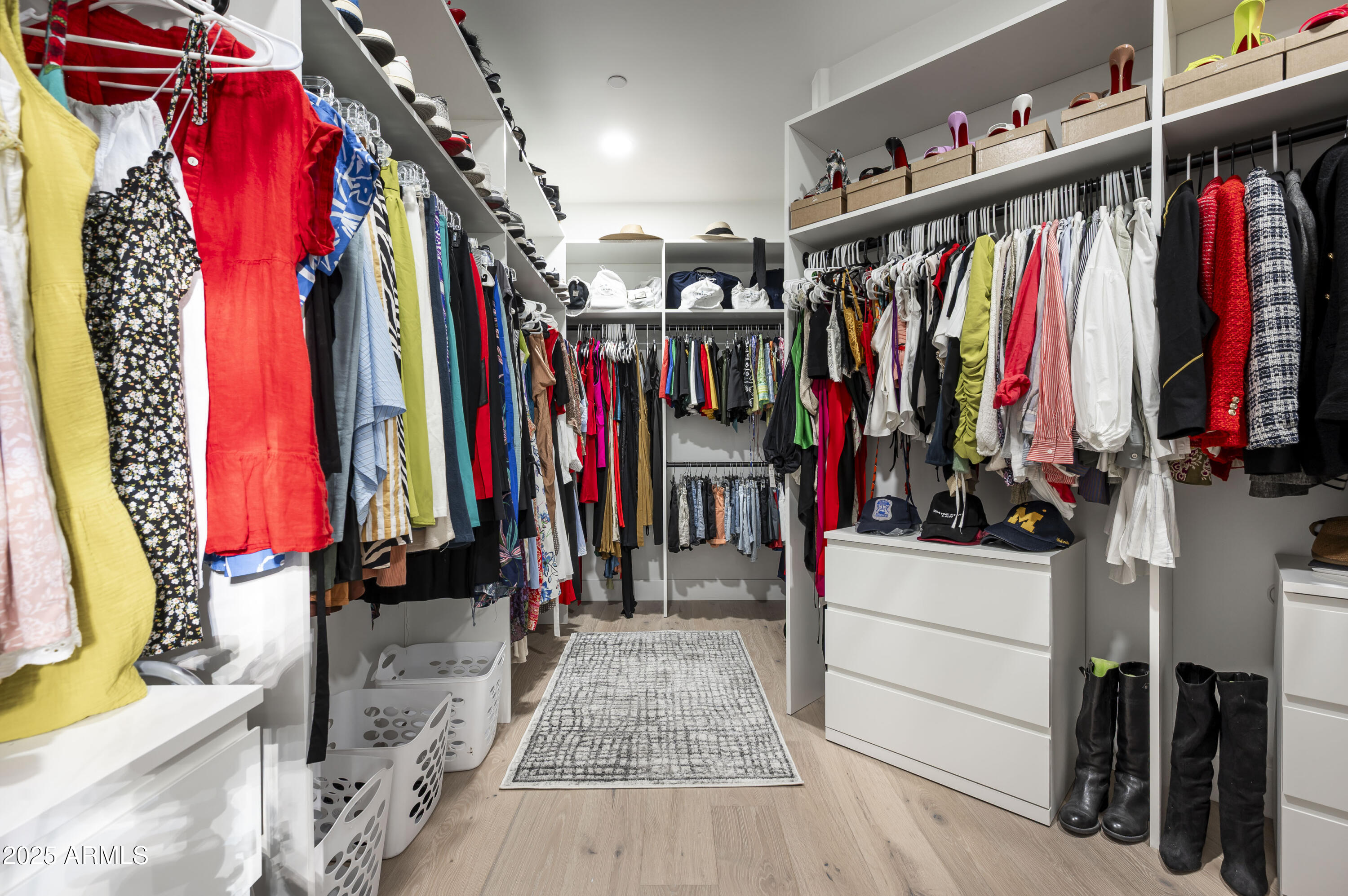 7614 East Cactus Wren Road Scottsdale, AZ 85250 - Photo 11 of 22 a view of walk in closet with clothes and shoes