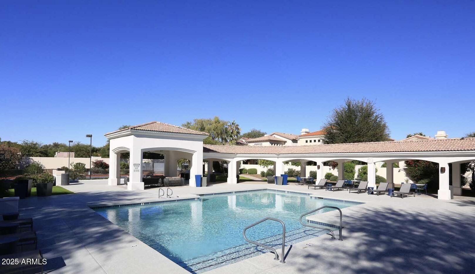 7614 East Cactus Wren Road Scottsdale, AZ 85250 - Photo 19 of 22 a view of a house with swimming pool and porch