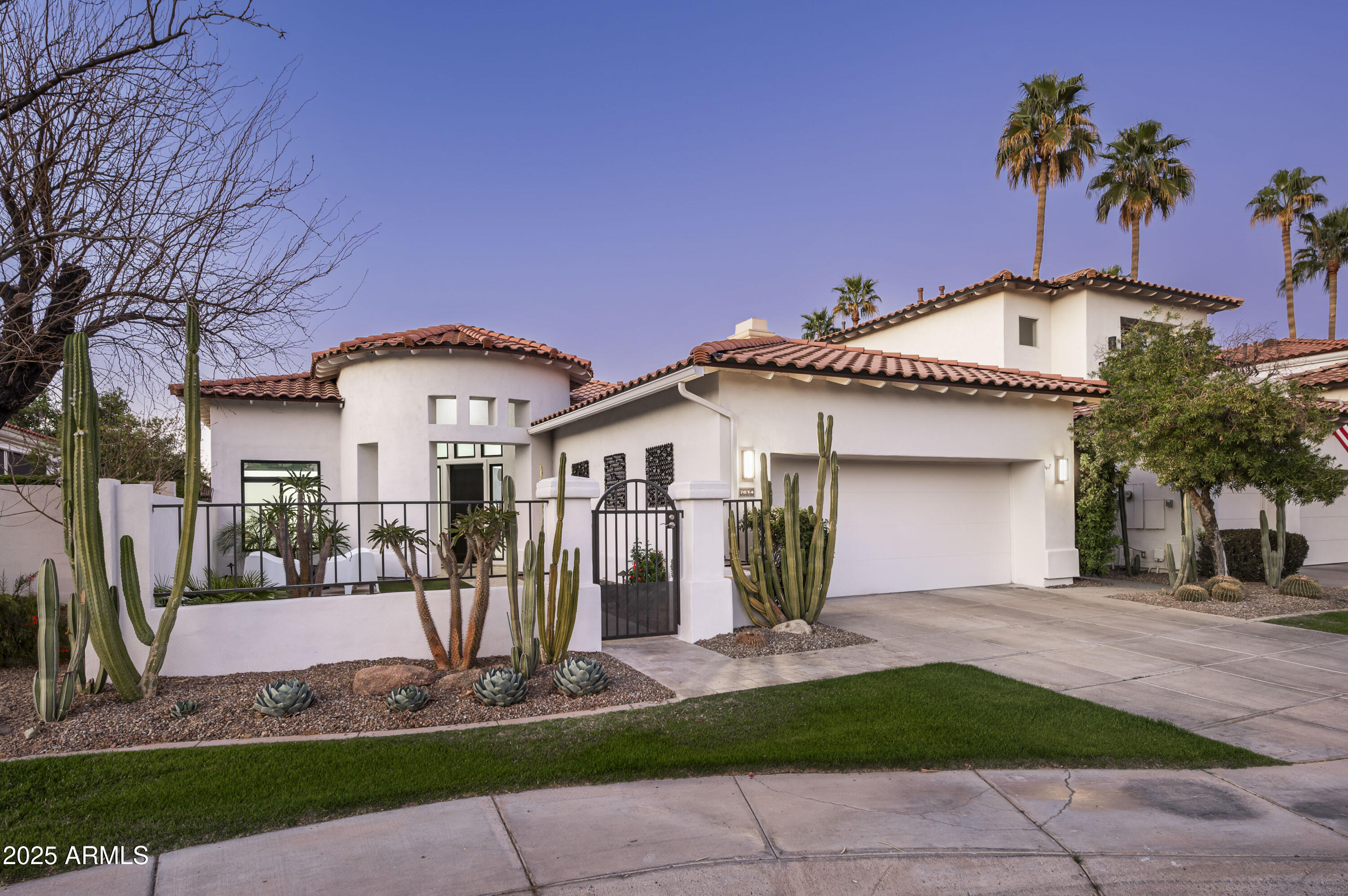 7614 East Cactus Wren Road Scottsdale, AZ 85250 - Photo 2 of 22 a front view of a house with garden