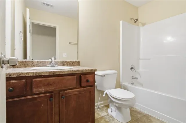 a bathroom with a sink toilet and a mirror