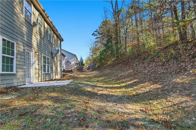 a view of a yard with large trees