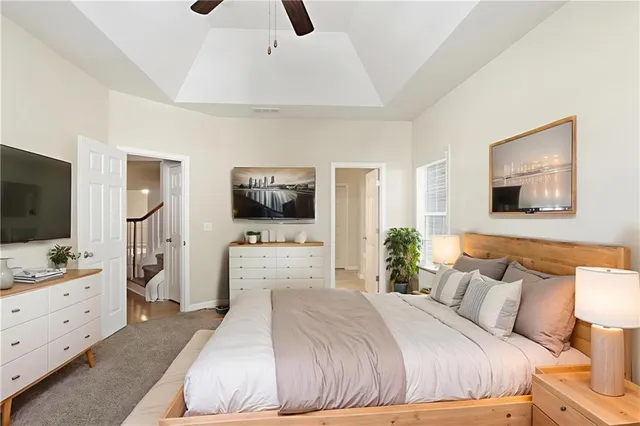 a bedroom with a large bed and a flat screen tv