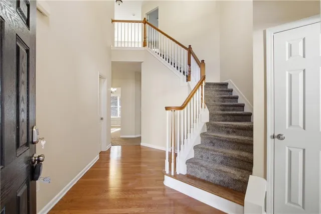 a view of entryway and hall with wooden floor