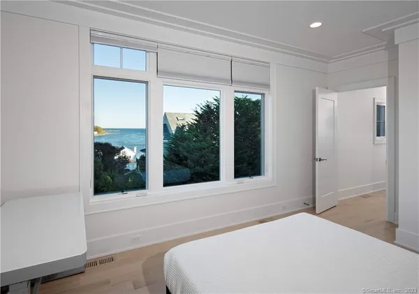 a bedroom with a bed and a large window