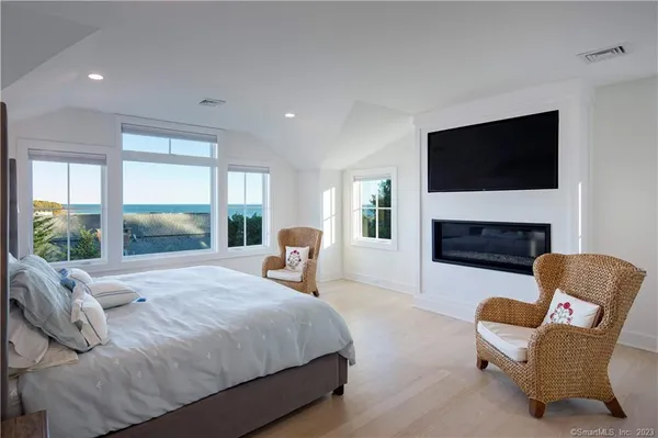 a spacious bedroom with a bed and a fireplace