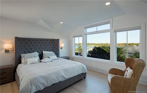 a bedroom with a large bed and a large window