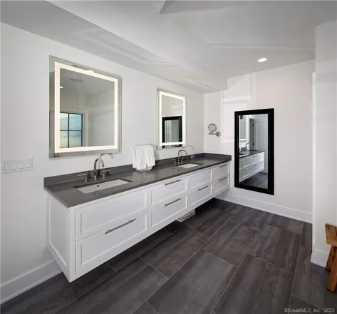 a hall with a sink and a large mirror