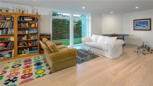 a living room with furniture and a book shelf
