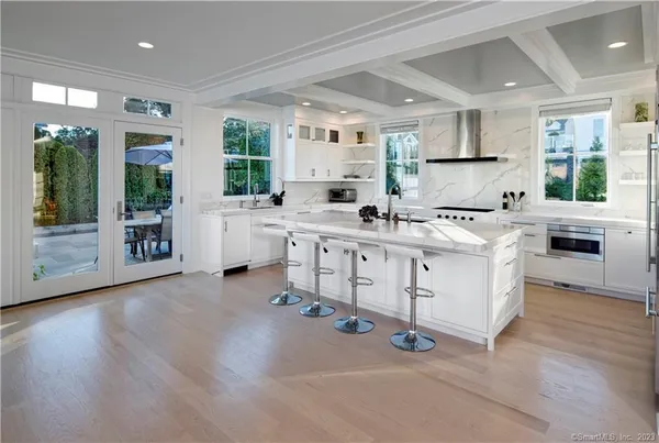 a kitchen with appliances a sink and cabinets