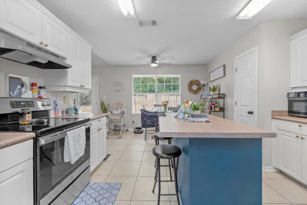 a kitchen with stainless steel appliances a stove a sink and a refrigerator