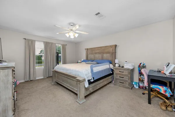 a bedroom with a bed and a tv