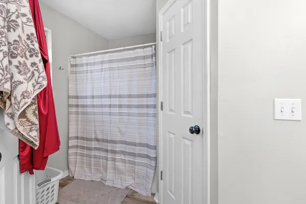 a bathroom with a shower curtain and a shower curtain