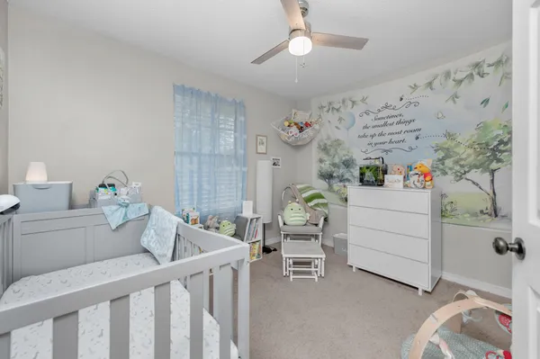 a bedroom with furniture and a baby crib