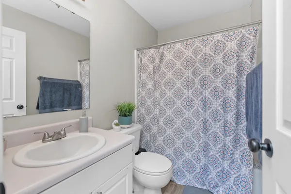 a bathroom with a sink toilet and mirror