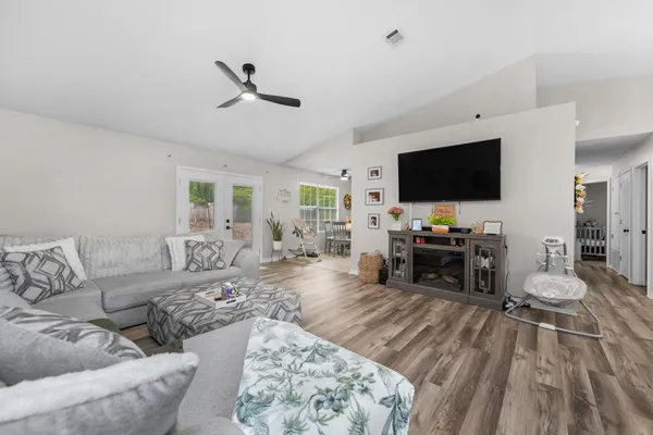 a living room with furniture and a flat screen tv