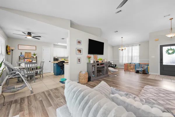 a living room with furniture and a flat screen tv