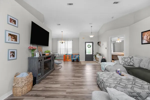 a living room with furniture and a flat screen tv
