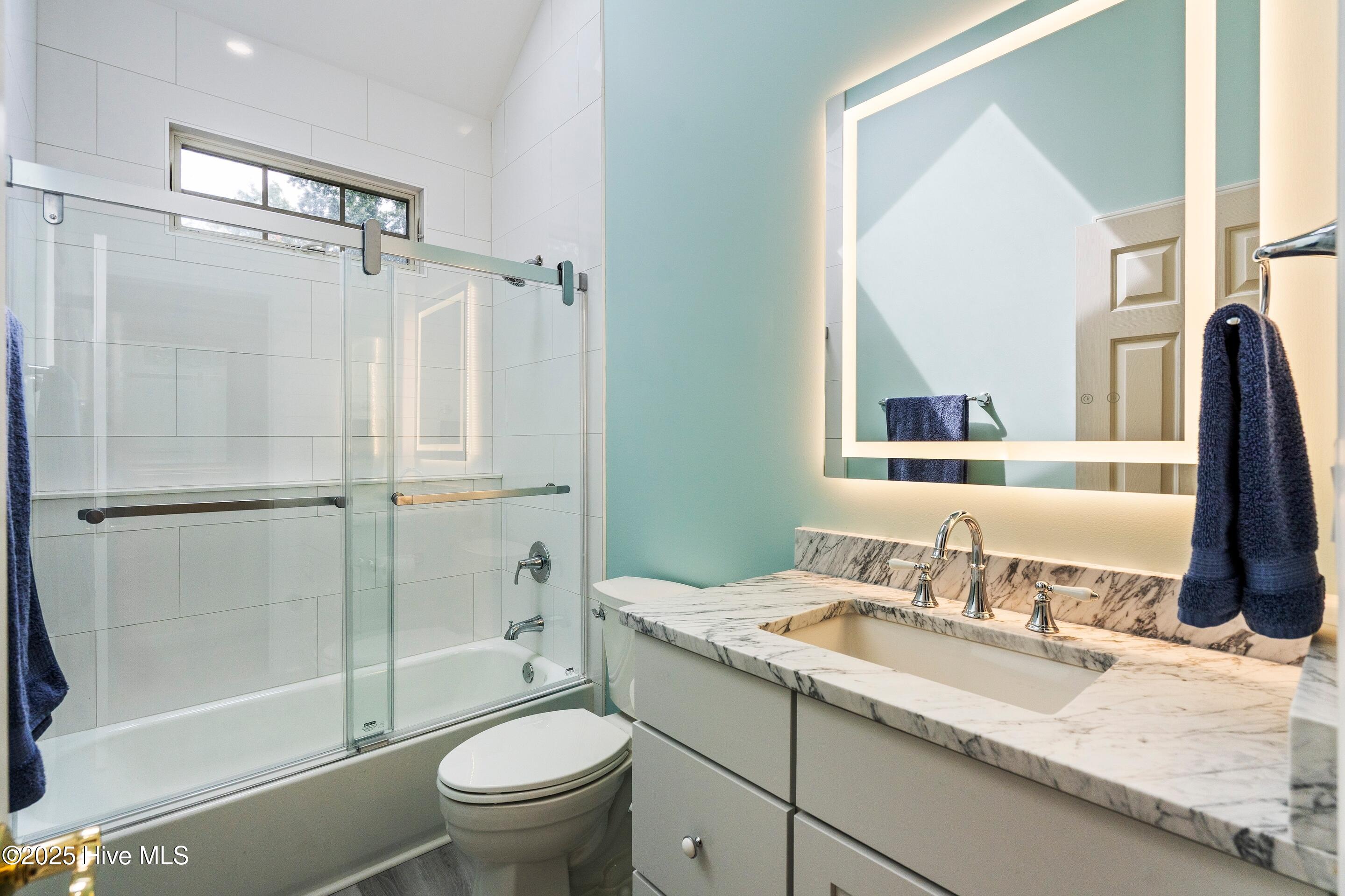 1020 Cordgrass Road Hampstead, NC 28443 - Photo 36 of 65 Updated guest bathroom with LED mirror