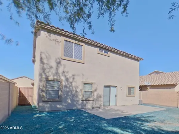 an empty room with windows and a ceiling fan