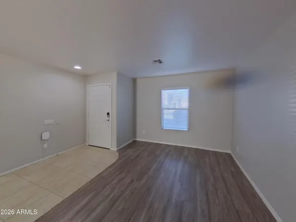 a view of a room with wooden floor and windows