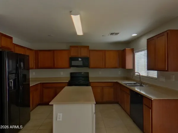 a kitchen with a refrigerator and a counter top space