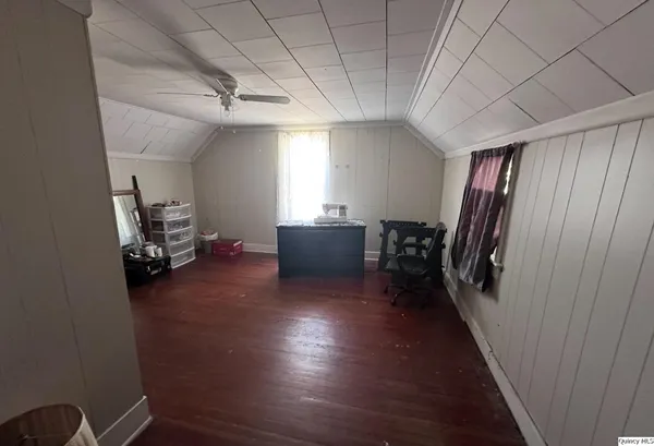 a view of a hallway with workspace and wooden floor