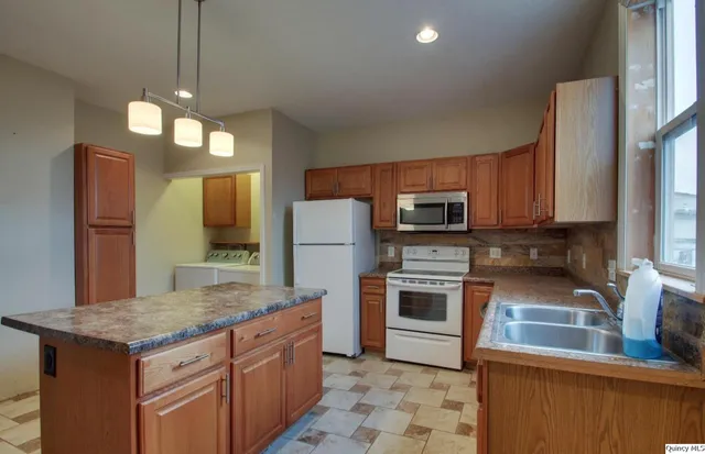 a kitchen with a stove a sink and a refrigerator