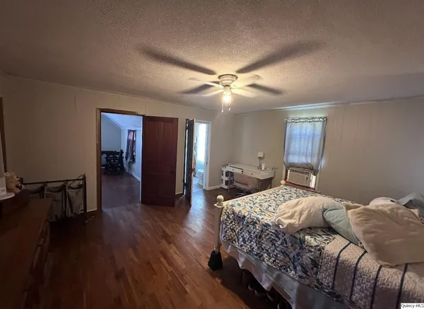 a bedroom with a bed chandelier and a window