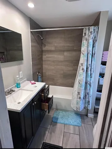 a bathroom with a sink a mirror and a shower