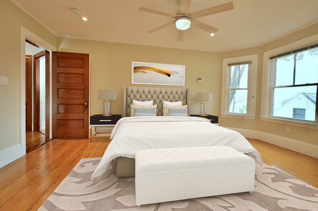 141 Beacon Street Boston, MA 02136 - Photo 21 of 40 a bedroom with a bed and wooden floor