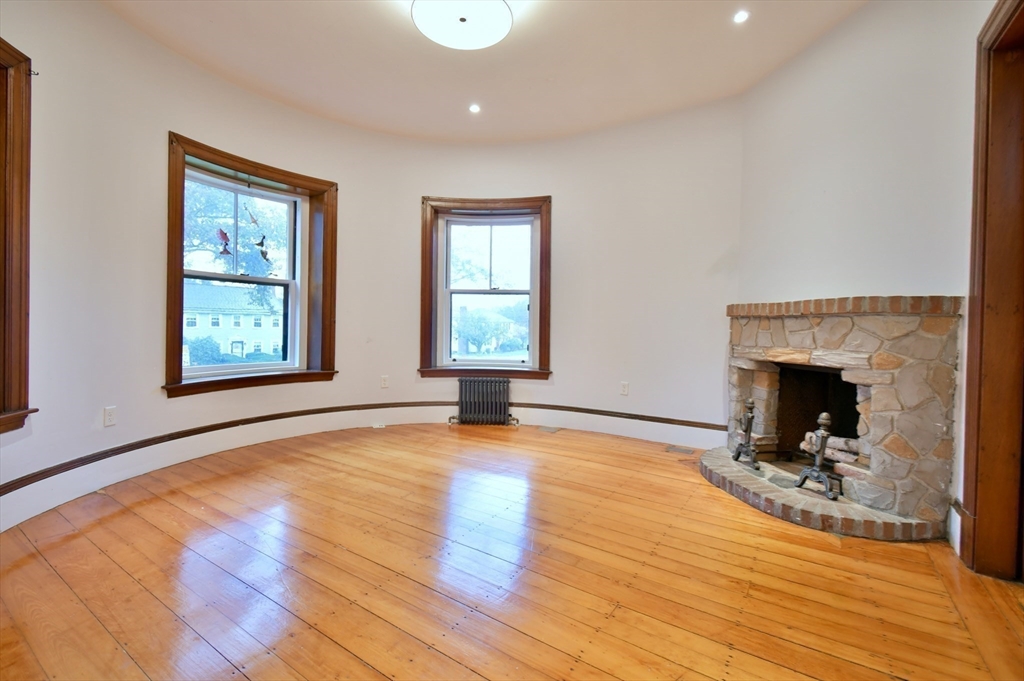 141 Beacon Street Boston, MA 02136 - Photo 29 of 40 a view of empty room with wooden floor and fireplace