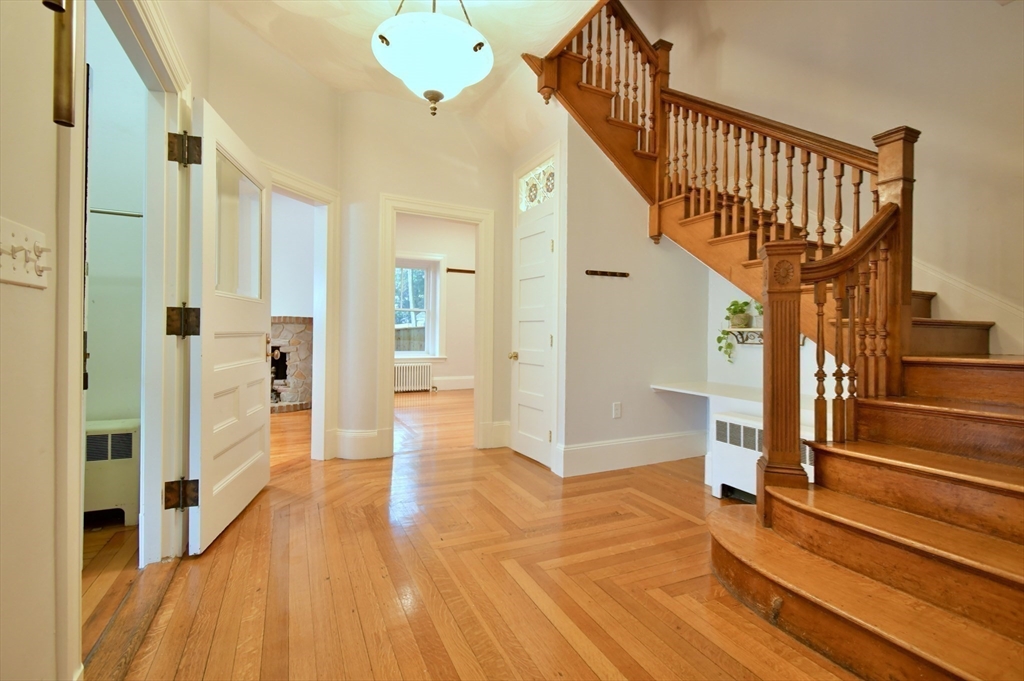 141 Beacon Street Boston, MA 02136 - Photo 7 of 40 a view of entryway with wooden floor and stairs