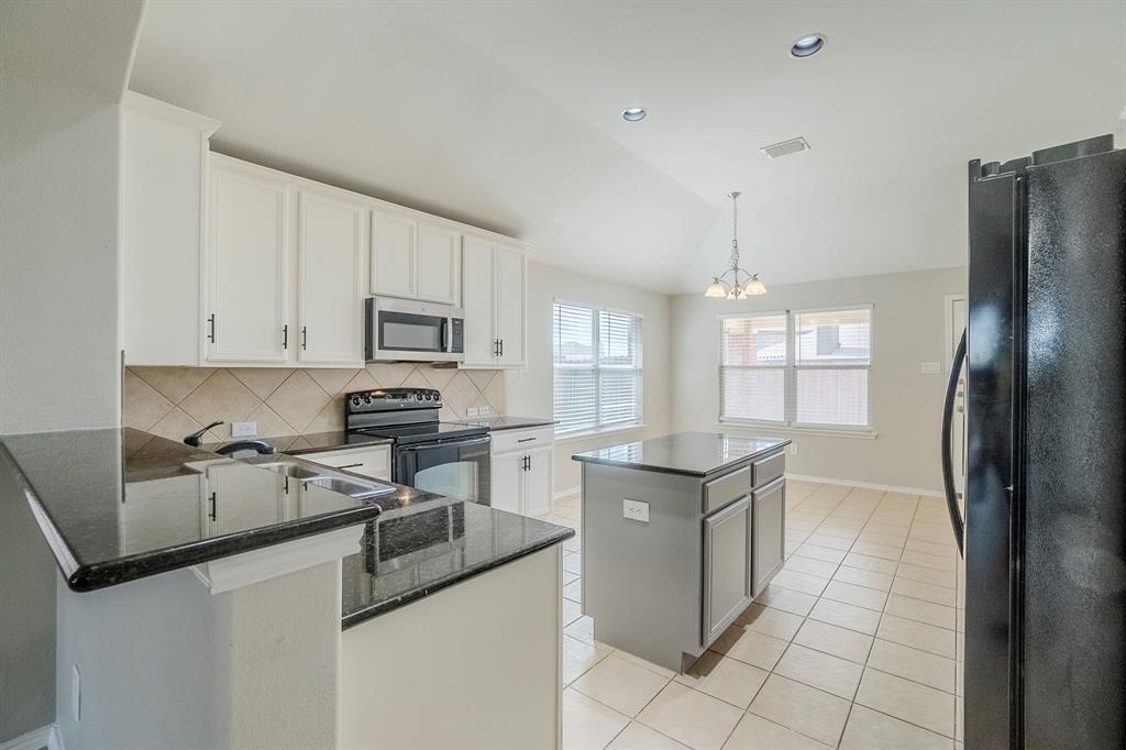 1109 Johnson City Avenue Forney, TX 75126 - Photo 11 of 40 a kitchen with stainless steel appliances granite countertop a sink stove and refrigerator