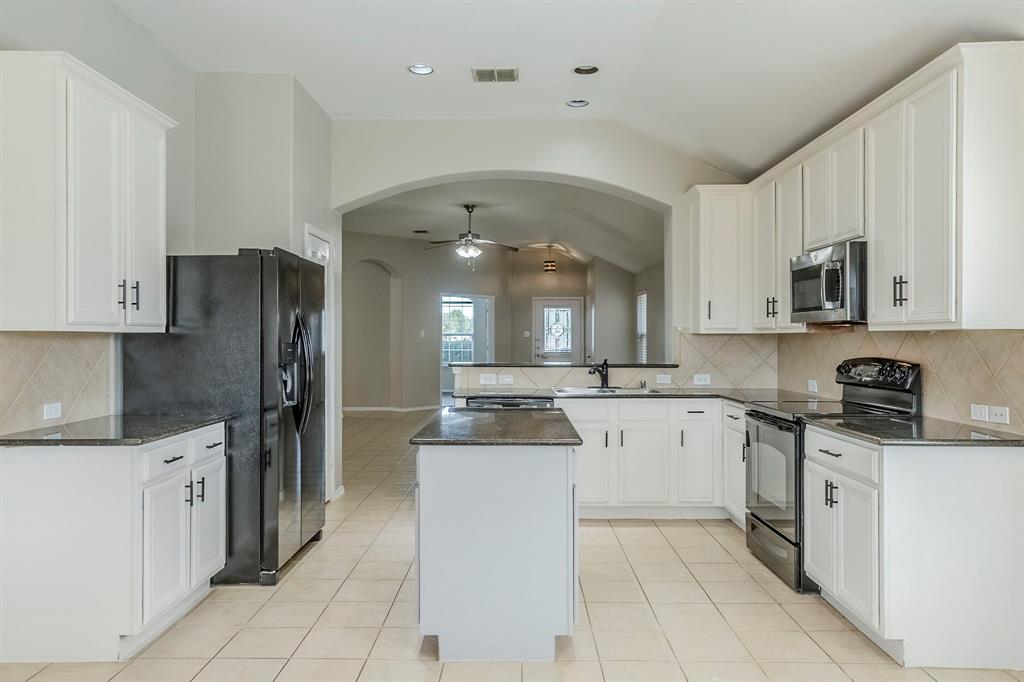 1109 Johnson City Avenue Forney, TX 75126 - Photo 12 of 40 a kitchen with a sink a counter top space and stainless steel appliances