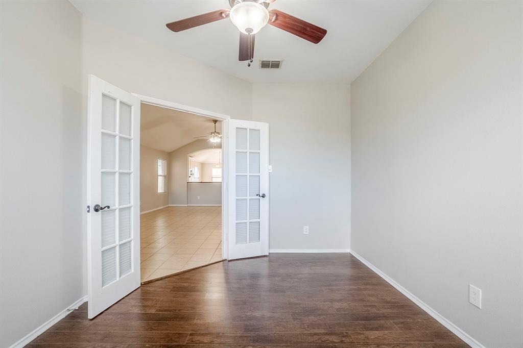 1109 Johnson City Avenue Forney, TX 75126 - Photo 21 of 40 wooden floor in an empty room with a window