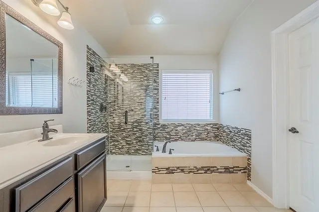 a bathroom with a sink a granite counter and a mirror