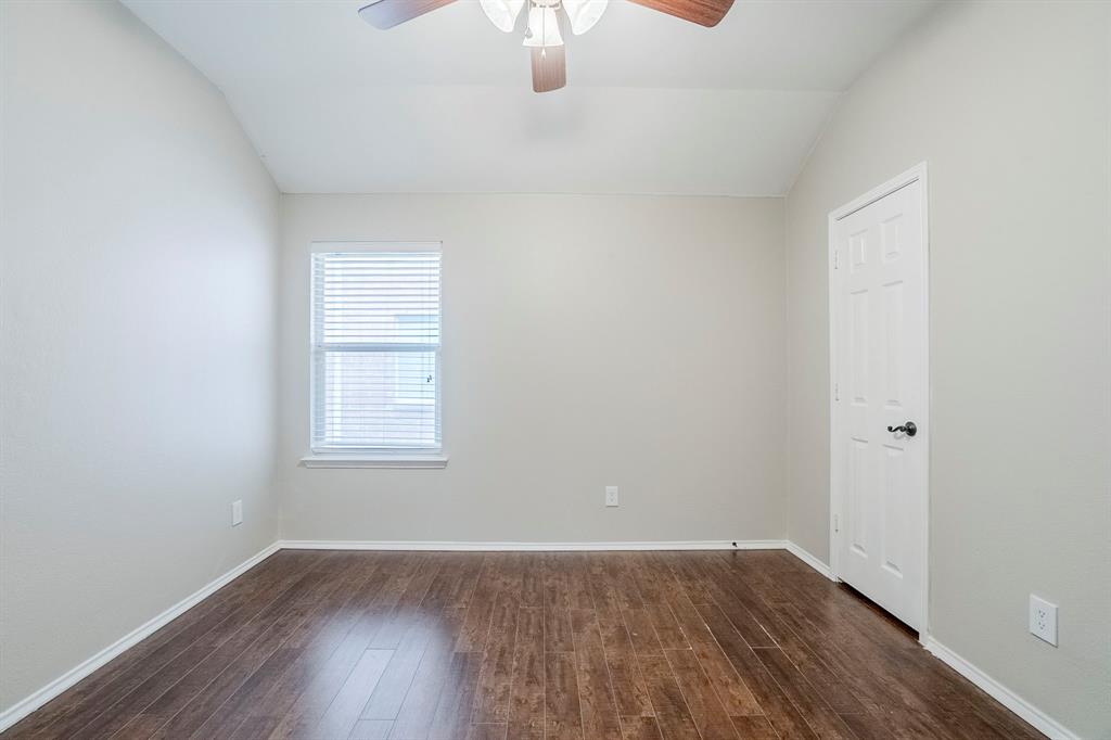 1109 Johnson City Avenue Forney, TX 75126 - Photo 31 of 40 an empty room with wooden floor cabinet and windows