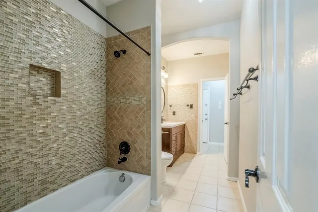 a bathroom with a tub a sink and a shower
