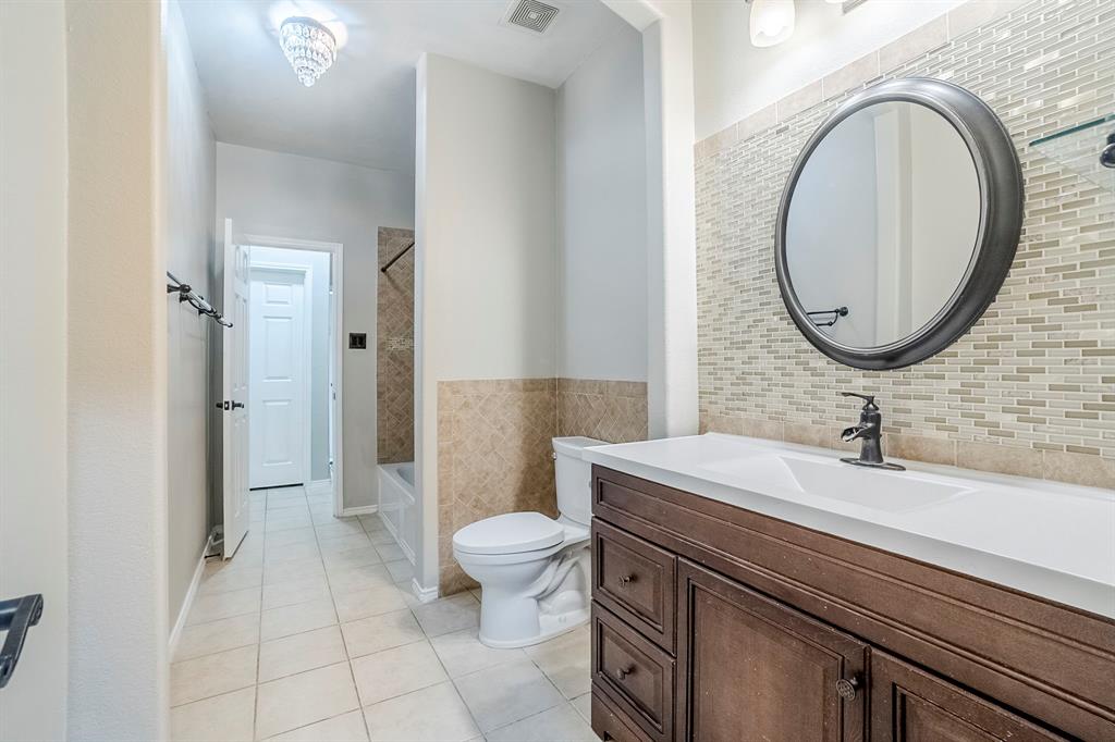 1109 Johnson City Avenue Forney, TX 75126 - Photo 34 of 40 a bathroom with a sink a toilet and a mirror
