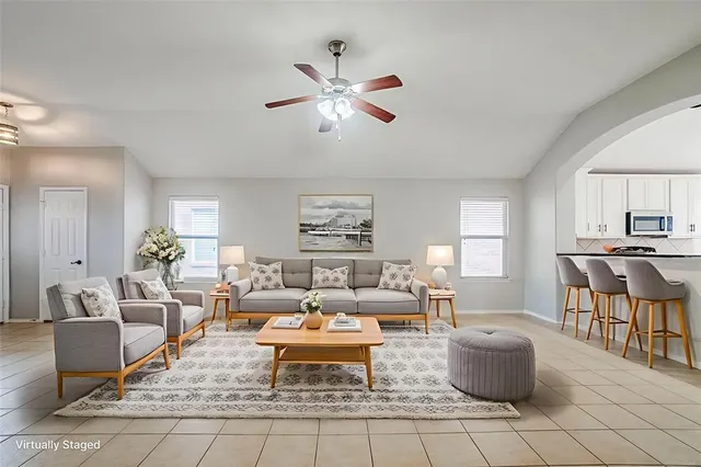 a living room with furniture and a large window