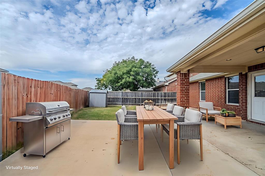 1109 Johnson City Avenue Forney, TX 75126 - Photo 10 of 40 a patio with a table and chairs