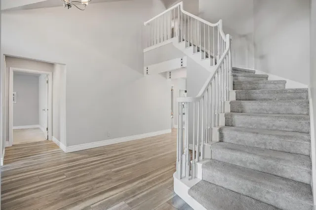 a living room with fireplace furniture and a wooden floor
