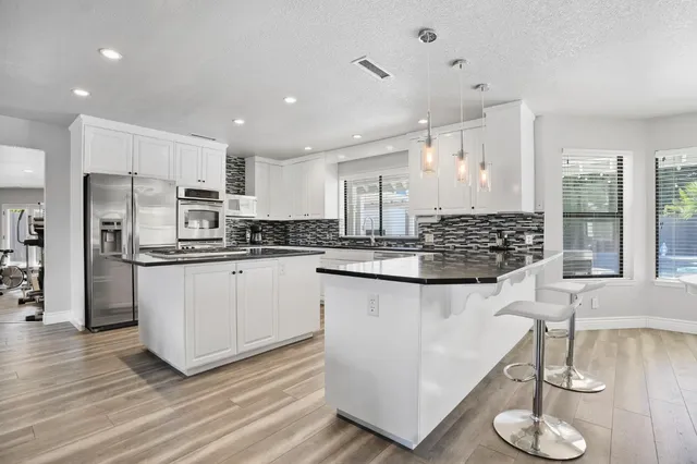 a room with appliances and cabinets
