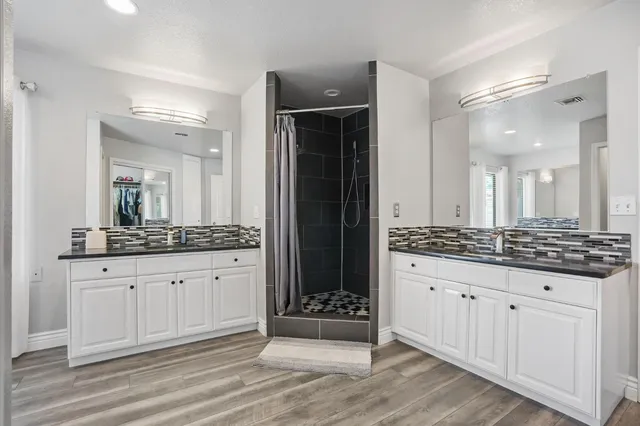 a spacious bedroom with a bed and a chandelier