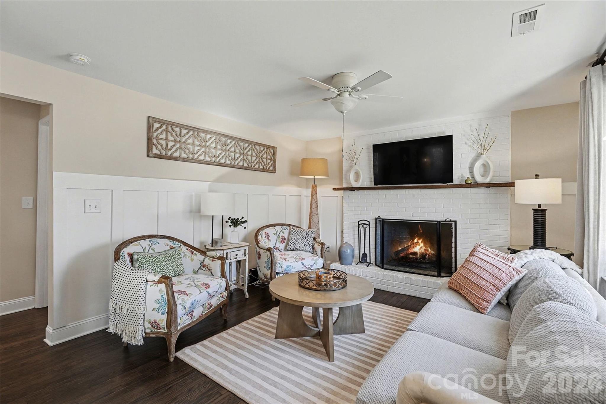 1760 Shearers Road Davidson, NC 28036 - Photo 2 of 18 a living room with furniture a fireplace and a flat screen tv