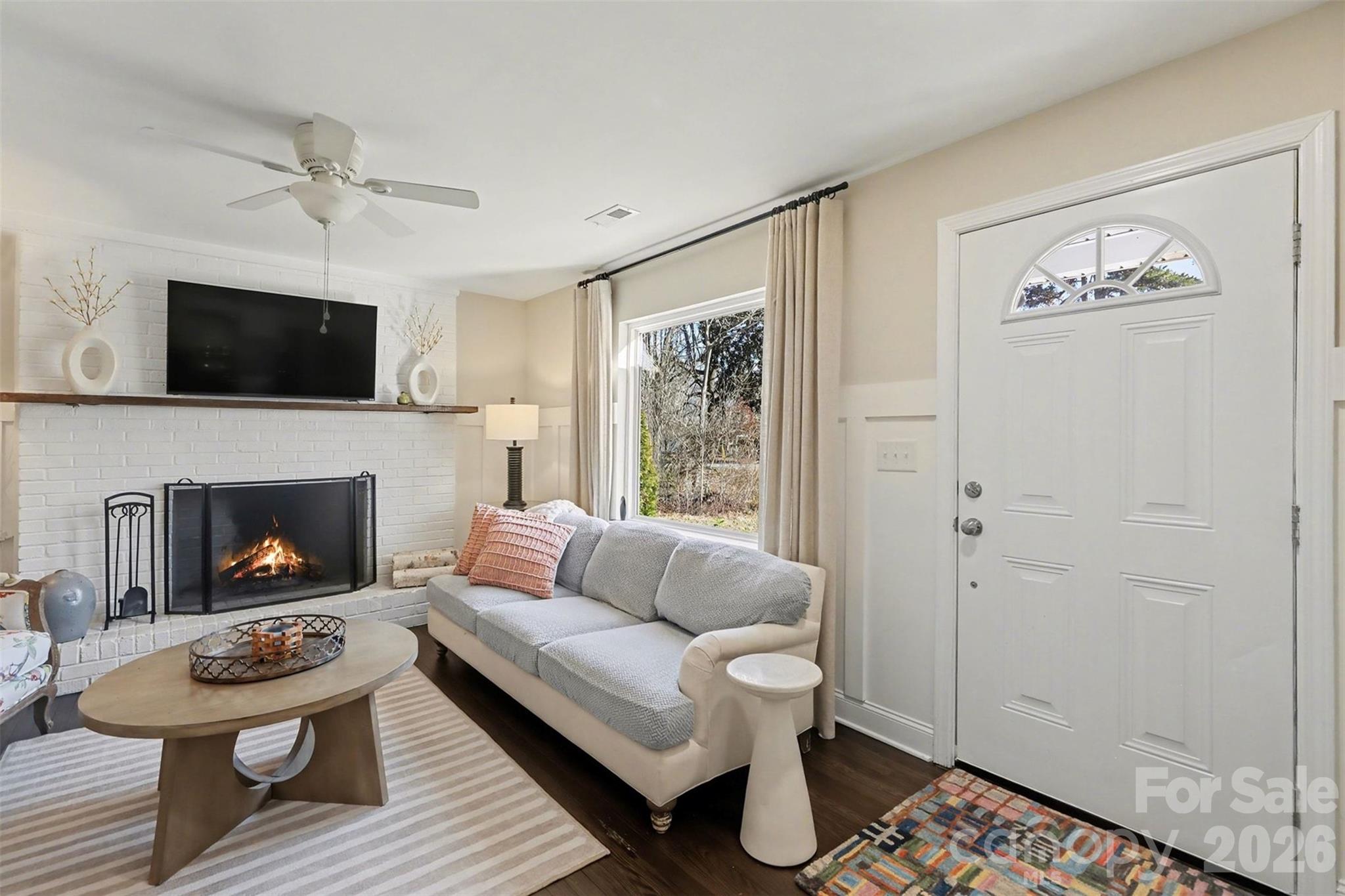 1760 Shearers Road Davidson, NC 28036 - Photo 3 of 18 a living room with furniture a fireplace and a flat screen tv