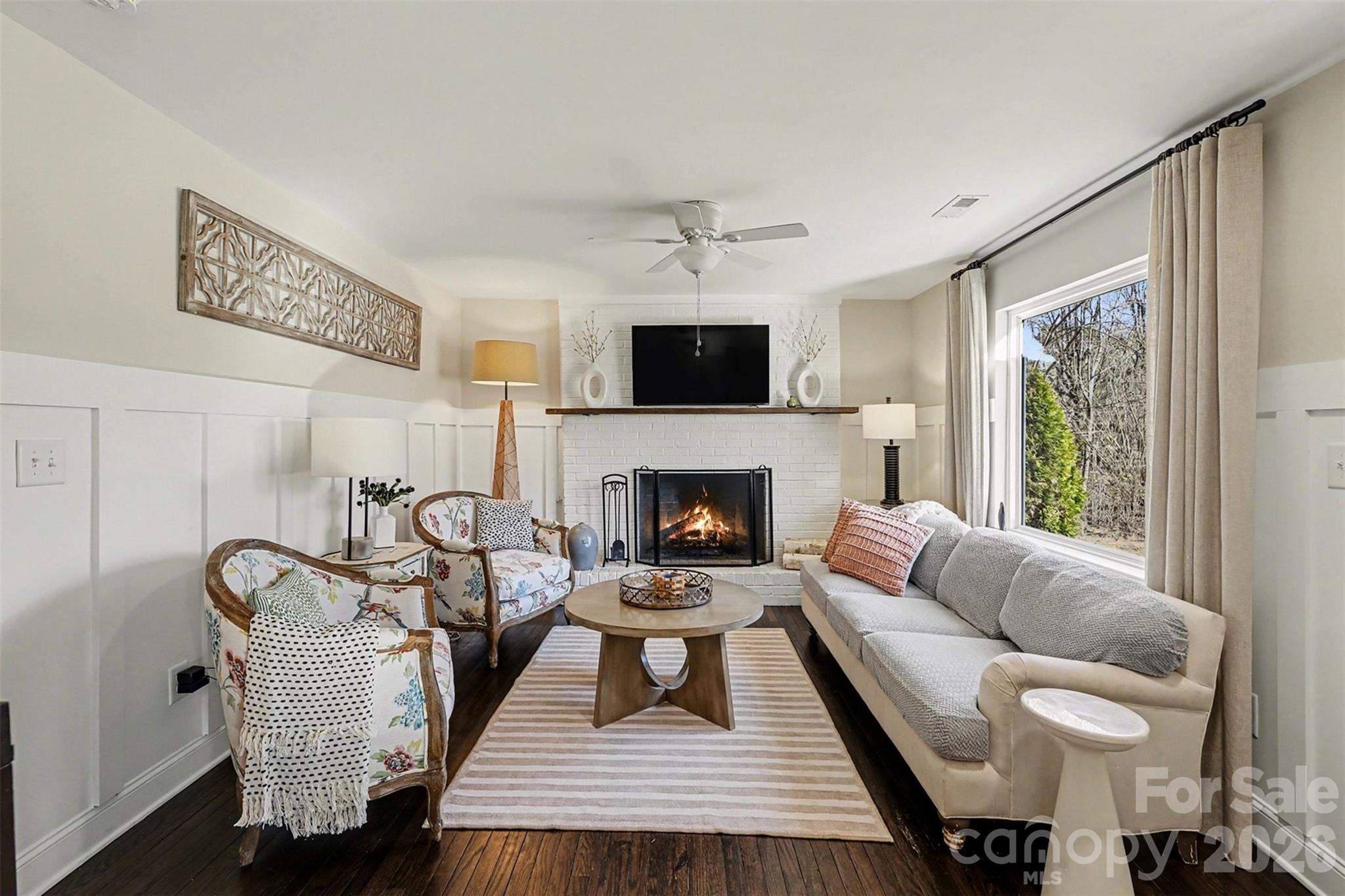 1760 Shearers Road Davidson, NC 28036 - Photo 4 of 18 a living room with furniture a flat screen tv and a fireplace