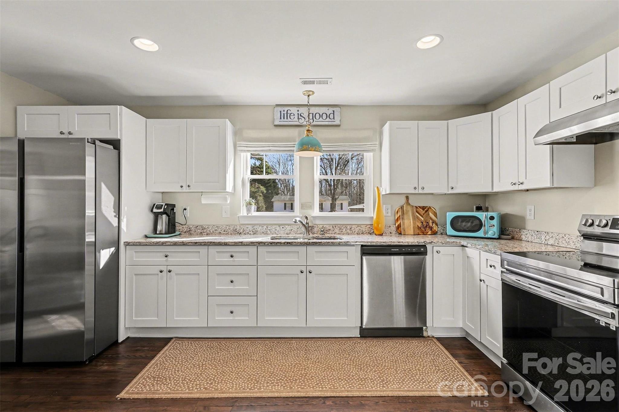 1760 Shearers Road Davidson, NC 28036 - Photo 8 of 18 a kitchen with stainless steel appliances granite countertop a stove a sink and a refrigerator