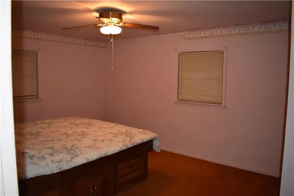 a view of a small space with wooden floor and a window